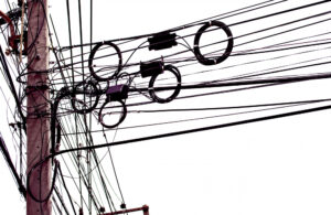 Complex nest of power lines on a pole